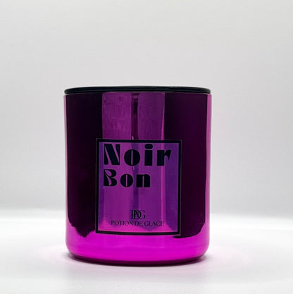 Noir Bon candle by Potion de Glace, with a mirrored pink container, made from natural soy wax and infused with a cherry fragrance. A luxurious piece to create a warm and fragrant ambiance in any space.