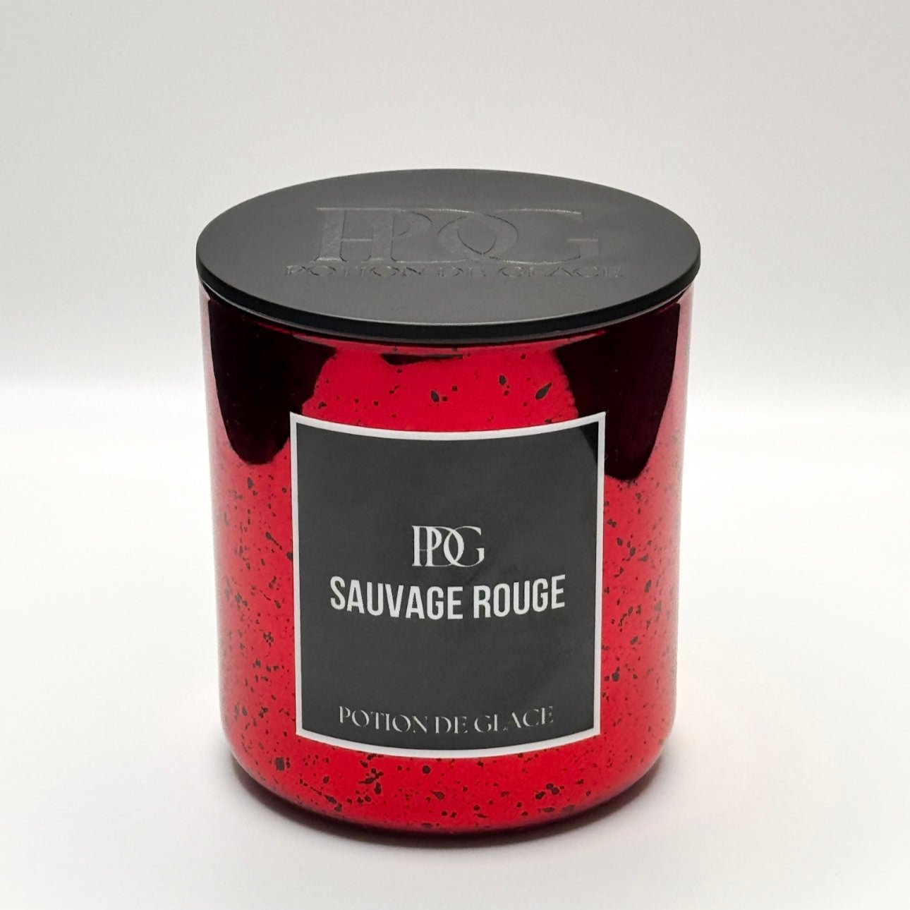 Sauvage Rouge luxury candle in a red glass vessel. A sophisticated, elegant design paired with a rich, sensual fragrance. hand poured, scented candle, eco-friendly.